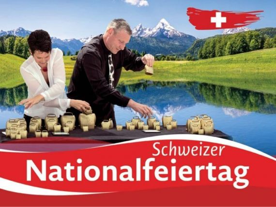 Menschen am Käsetisch vor den Alpen Schweizer Nationalfeiertag