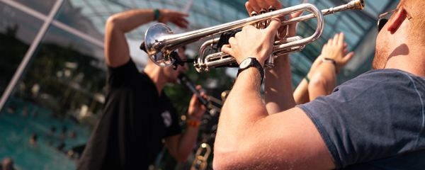 drei Personen liegen in Pool mit Cocktails